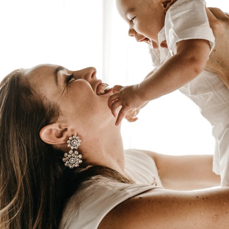 Photo by Jonathan Borba woman holding baby up